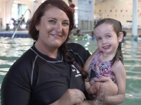 swim instructor with child